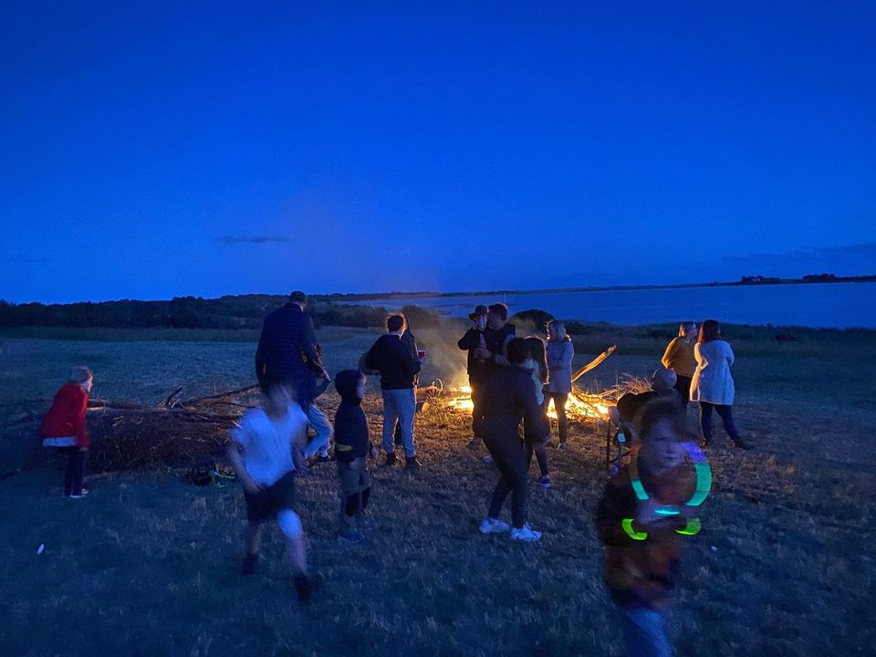 Campfire under a deep-blue evening sky